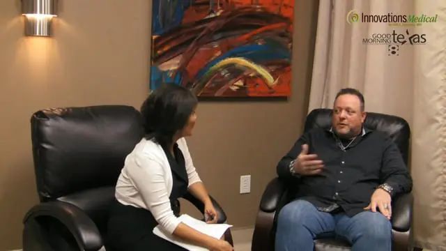A woman and a man sit in black chairs having a conversation about regenerative therapy in an office setting. The woman holds a notepad. Abstract artwork decorates the wall, alongside Innovations Medical and Good Morning Texas logos.